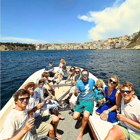 A group of people on a boat with a coastal town in the background. 5