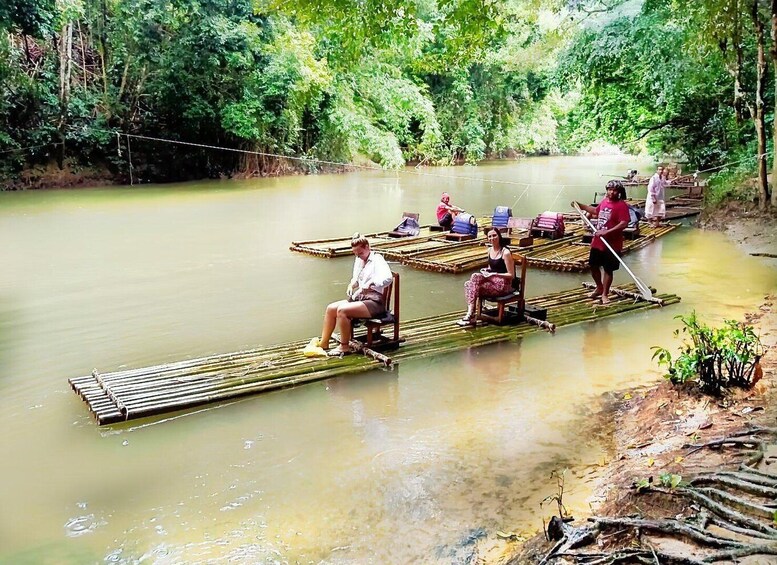 People on floating platforms in a river surrounded by dense greenery. 3