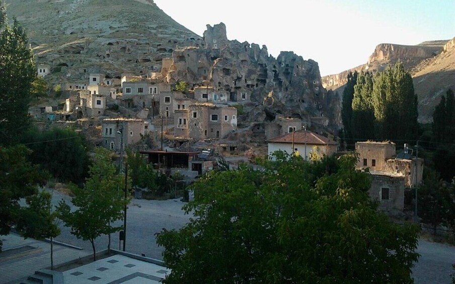 A village nestled in a mountainous area with traditional stone buildings. 4
