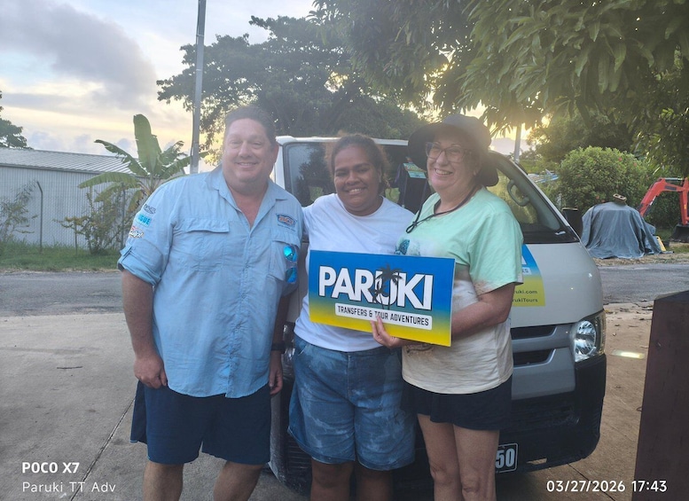 Three people standing in front of a white van with a sign that reads 'PARUKI Transfers & Tour Adventures.' 4