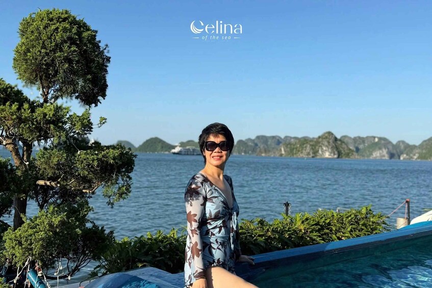 A person by a pool with a view of the sea and distant islands. 3