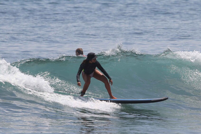 A person surfing on a wave in the ocean. 4