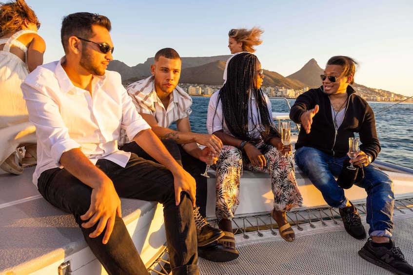 A group of people on a boat with a mountainous landscape in the background. 4
