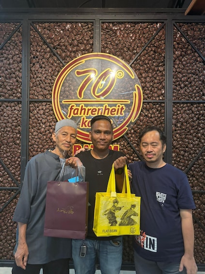 Three people standing in front of a sign with '70° Fahrenheit' and 'flat-bean' text. 1