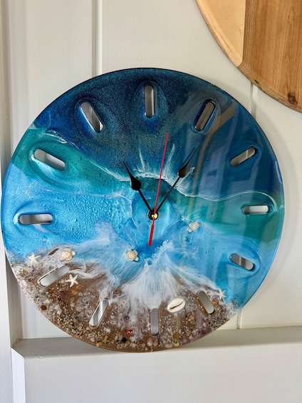 A wall clock with a marine-themed design, featuring sea creatures and a wave pattern. 2