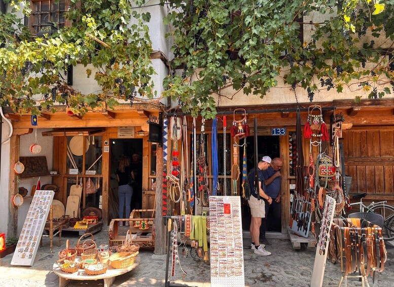A street market with various stalls selling crafts and food. 5