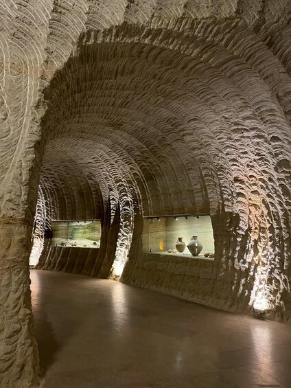 An underground passage with arched ceilings and stone walls. 5