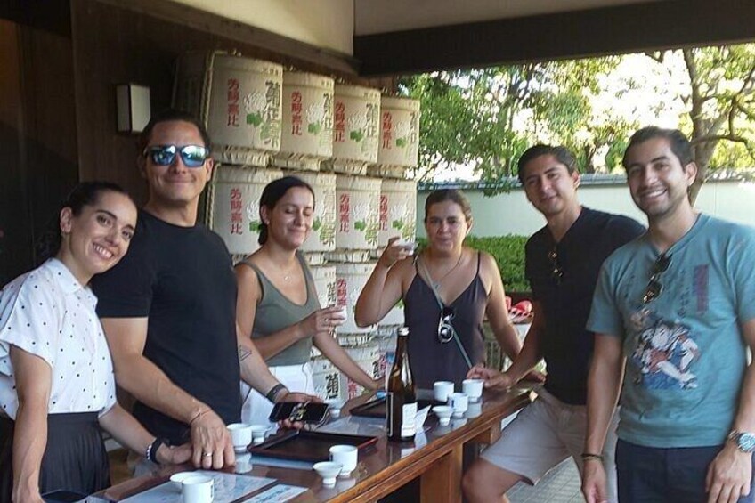 A group of people standing at a counter with cups and a menu. 3