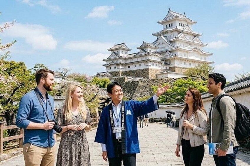 A group of people standing in front of a castle with traditional architecture. 1
