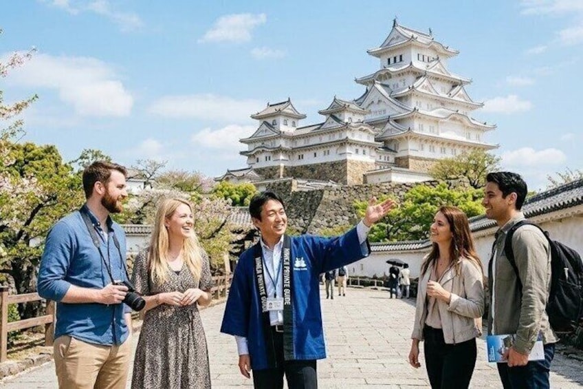 A group of people standing in front of a castle-like structure with traditional architecture. 1