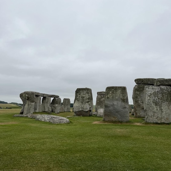 Stonehenge standing in a grassy field. 1