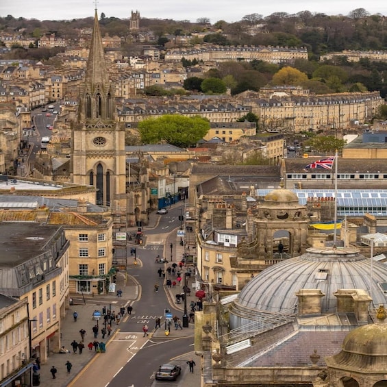 A historic cityscape with a prominent church tower, a dome, and a mix of residential and commercial buildings. 3
