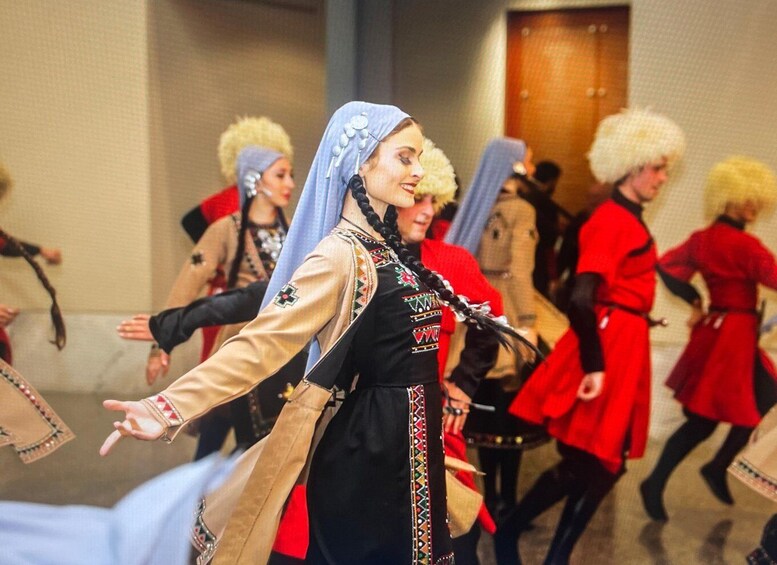 A group of people in traditional costumes performing a dance. 1