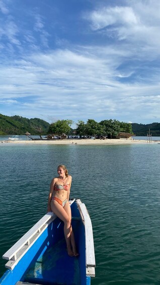 A woman in a bikini sitting on a boat. 1