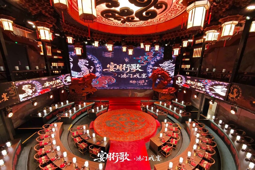 A theater with a red carpet, ornate ceiling, and traditional Chinese decorations. 1