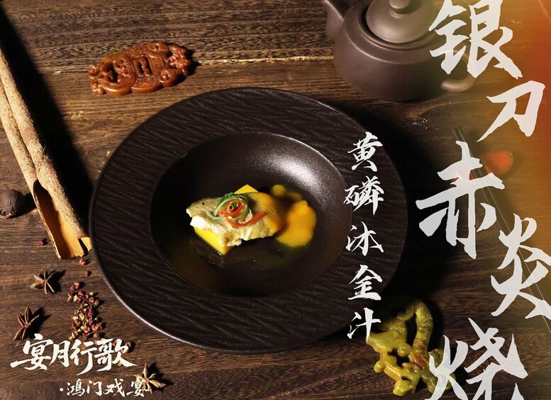A wooden table with a black plate containing a fish dish, surrounded by spices and a teapot. 5