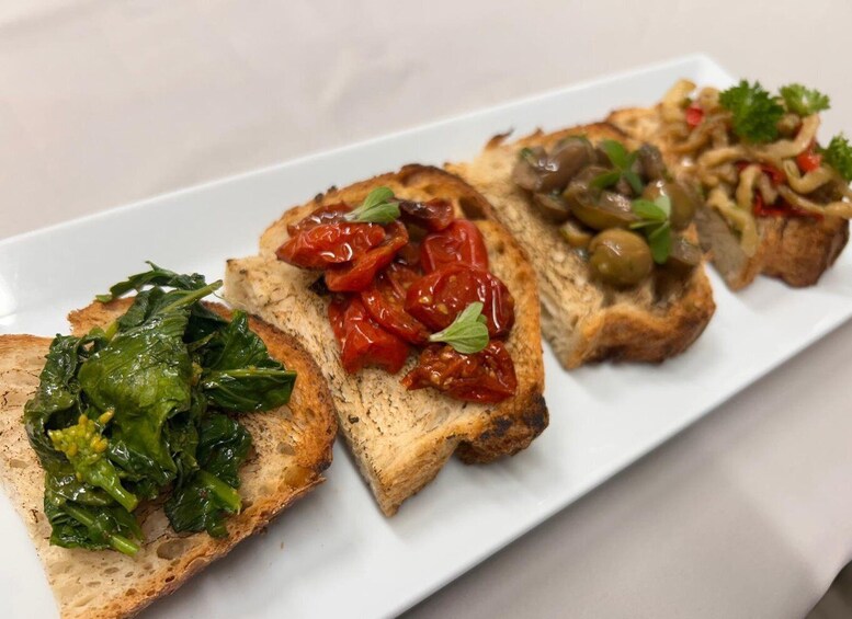 A plate with three different bruschetta toppings. 2