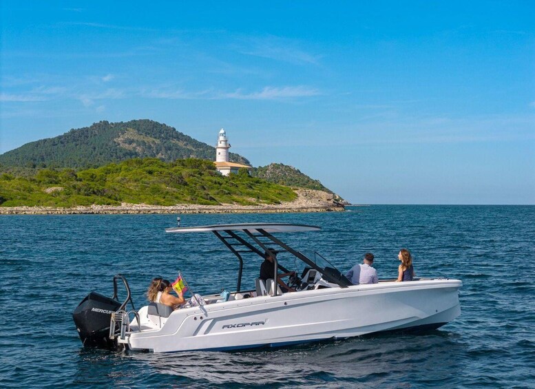 A white motorboat named 'AXOPAR' on calm waters with a lighthouse on a green island in the background. 5