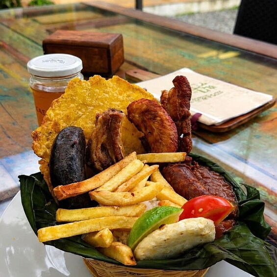 A meal with fried items, a bottle, and a menu on a table. 4