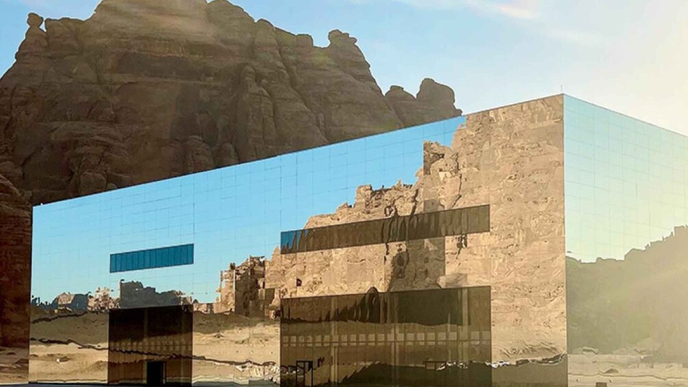 A modern glass building with a desert landscape in the background. 5