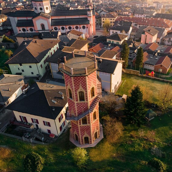 A town with a prominent tower and surrounding houses. 3