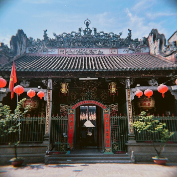 A traditional Chinese temple with ornate decorations, red lanterns, and a tiled roof. 4