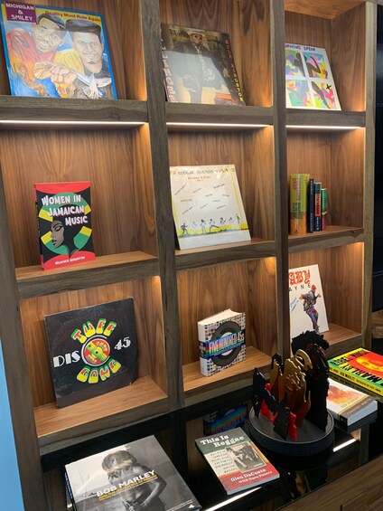 A bookshelf with various books and music memorabilia. 1