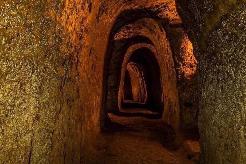 A cave with natural rock formations and a narrow passageway. 4