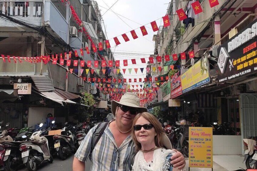 A street with shops, motorcycles, and red flags. 5