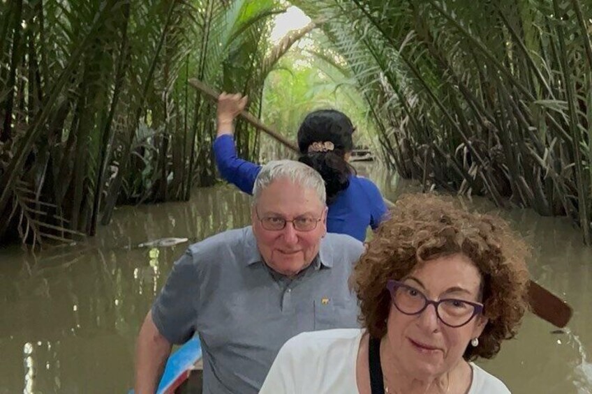 A person paddling through a mangrove forest. 1