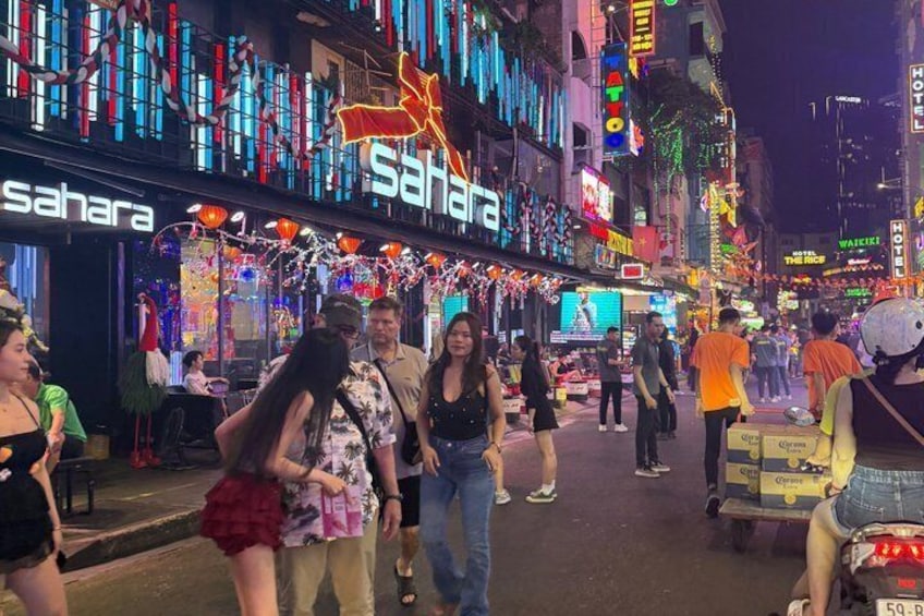 A busy street with illuminated signs, including 'Sahara' and 'The Ritz.' 4