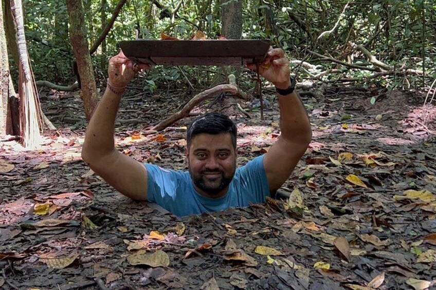 A person holding a wooden board above their head in a forest. 3