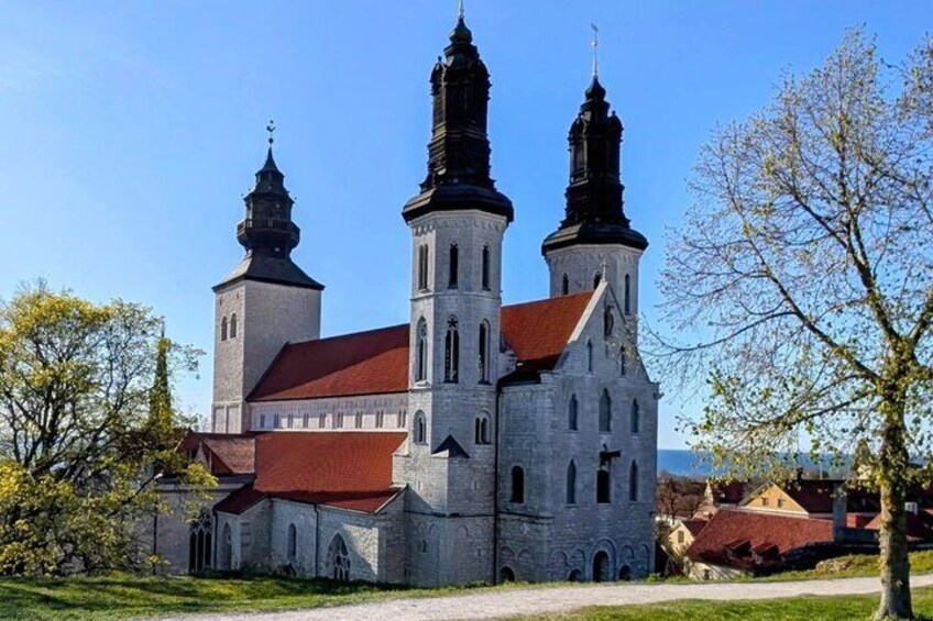 A historic church with two prominent towers and a red roof. 4