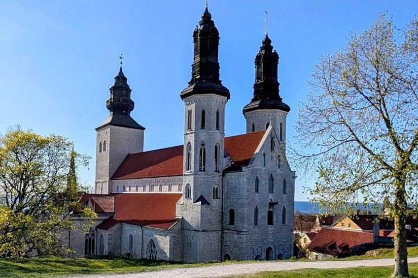 A historic church with two prominent towers and a red roof. 4