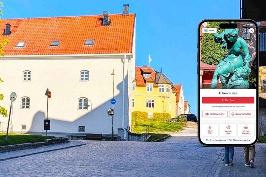 A cobblestone street, a white building with a red roof, and a smartphone displaying a map. 1