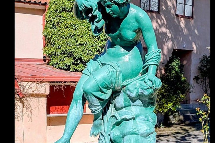 A bronze statue of a man carrying a child. 2