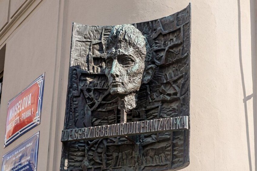 A bronze bust with inscriptions on a wall. 3