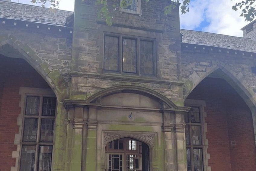 A stone building with arched windows and a central entrance. 2