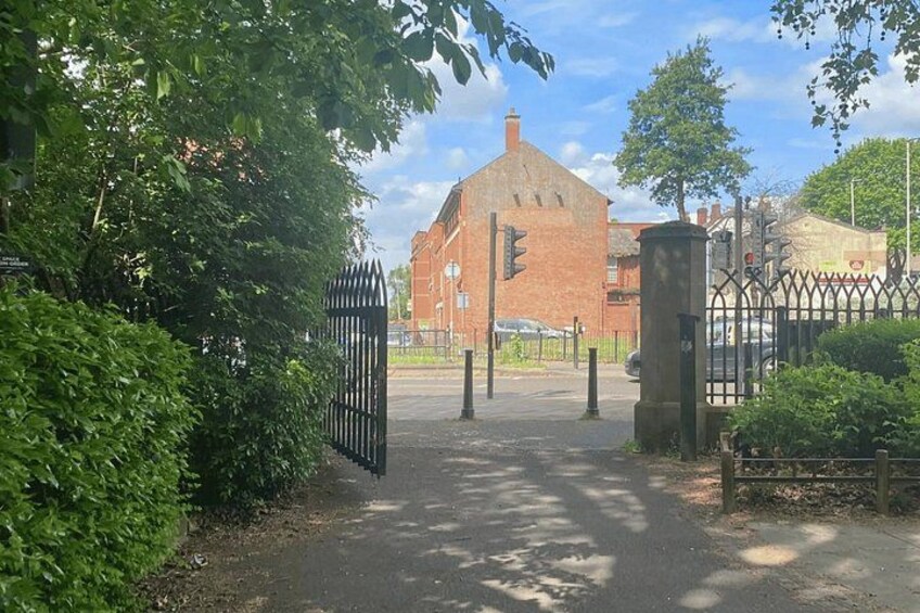A gated entrance with a brick building in the background. 4