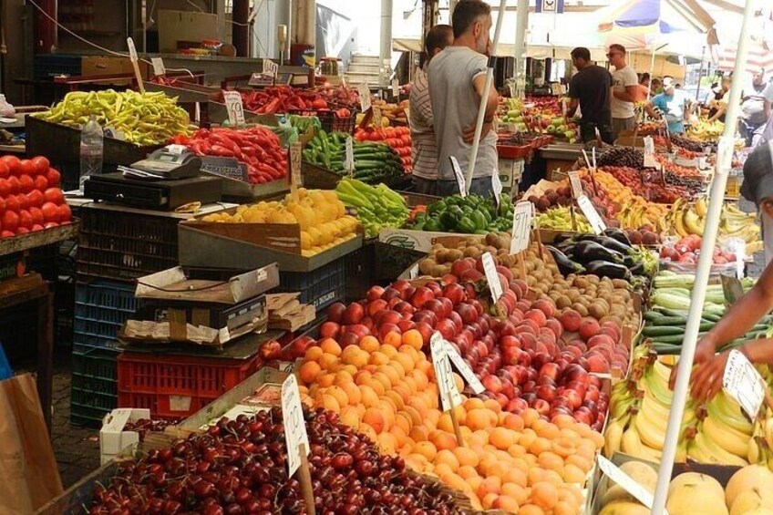 A bustling market with various fruits and vegetables on display. 5