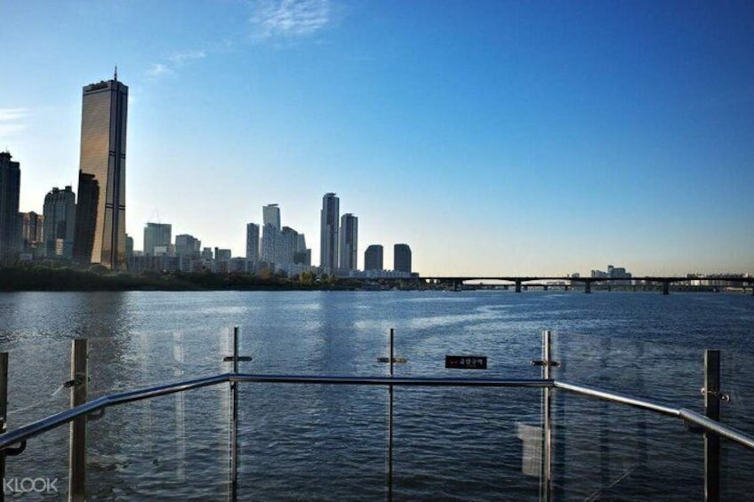 A river with a city skyline in the background, including a tall building. 1
