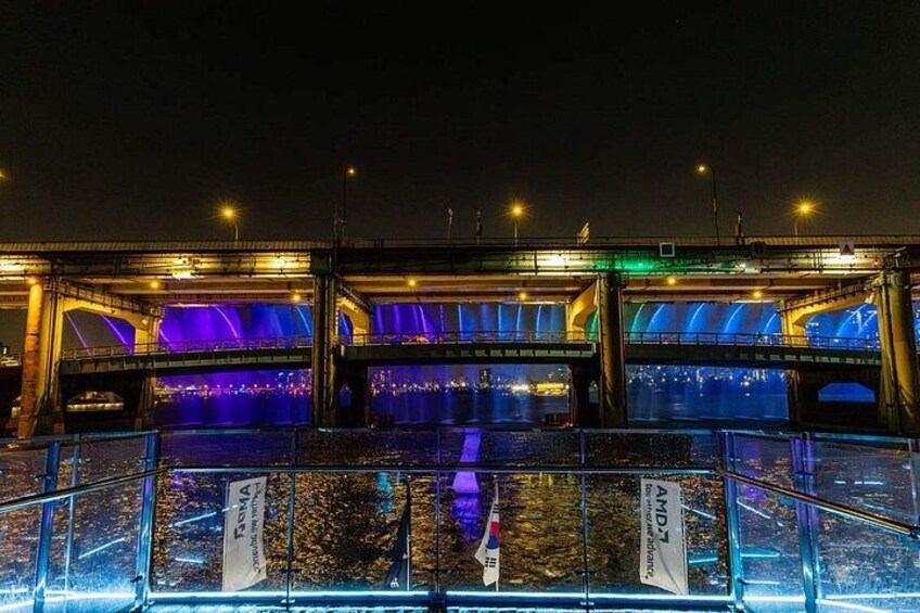 A bridge at night with illuminated arches and a river below. 3