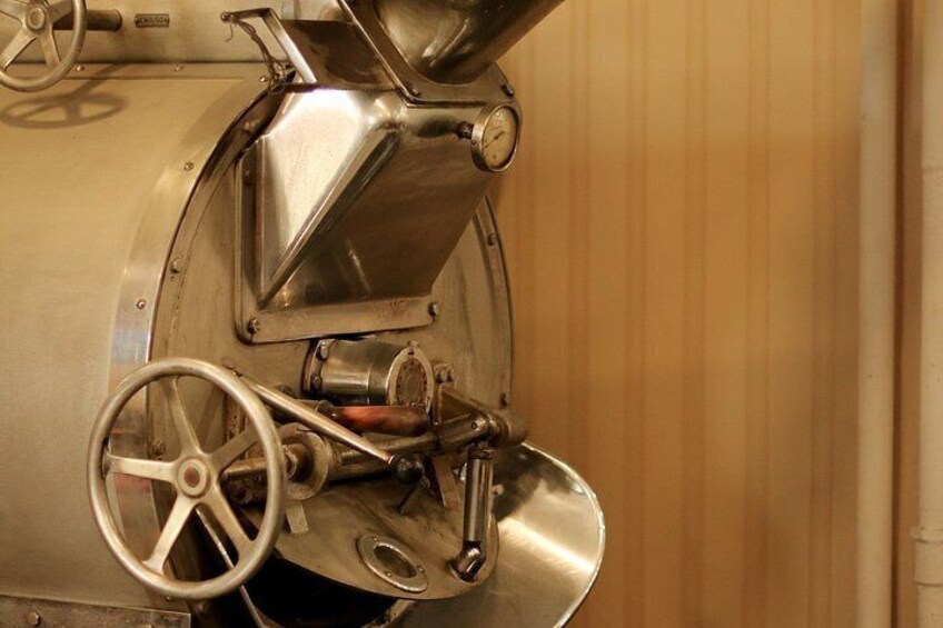A metallic industrial machine with a wheel and control knobs. 5