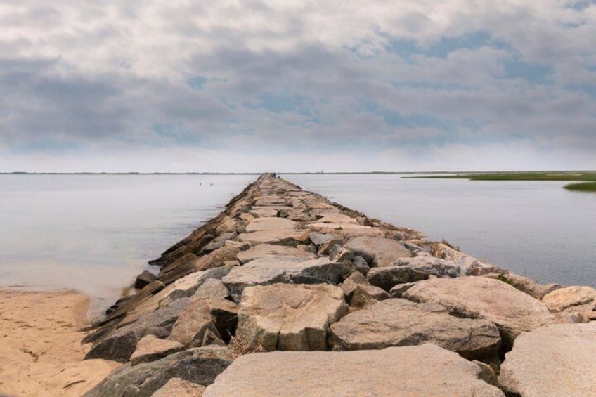 A rocky breakwater extending into calm waters. 3