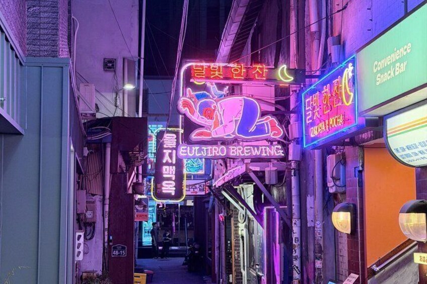 A narrow alley with neon signs, including one for 'Euljiro Brewing.' 1