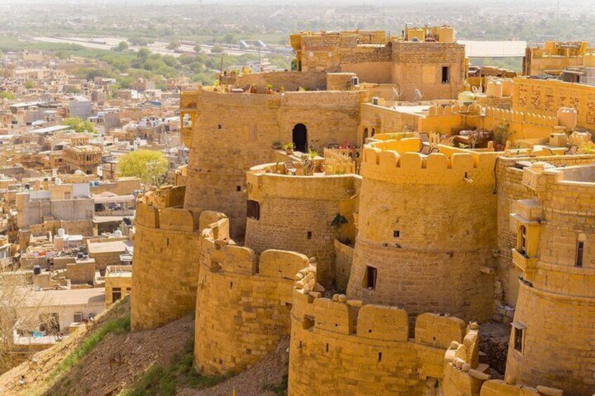 A historic fort with multiple towers and walls, surrounded by a cityscape. 5