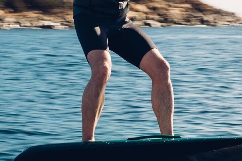 A person standing on a boat with water in the background. 4