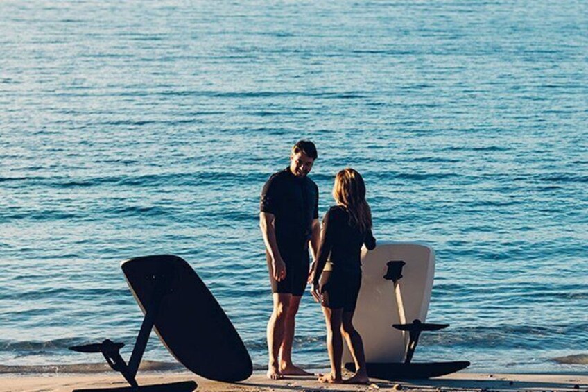 Two people standing by the sea with surfboards. 3