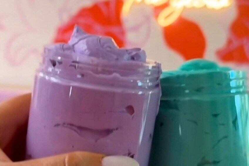 A hand holding a purple container with a heart-shaped cutout. 5