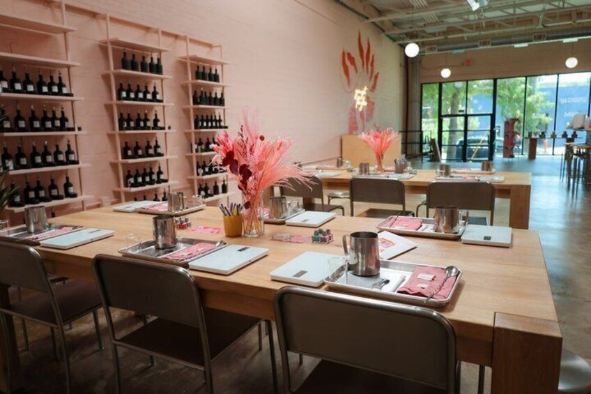 A restaurant with wooden tables, chairs, and shelves of bottles. 4